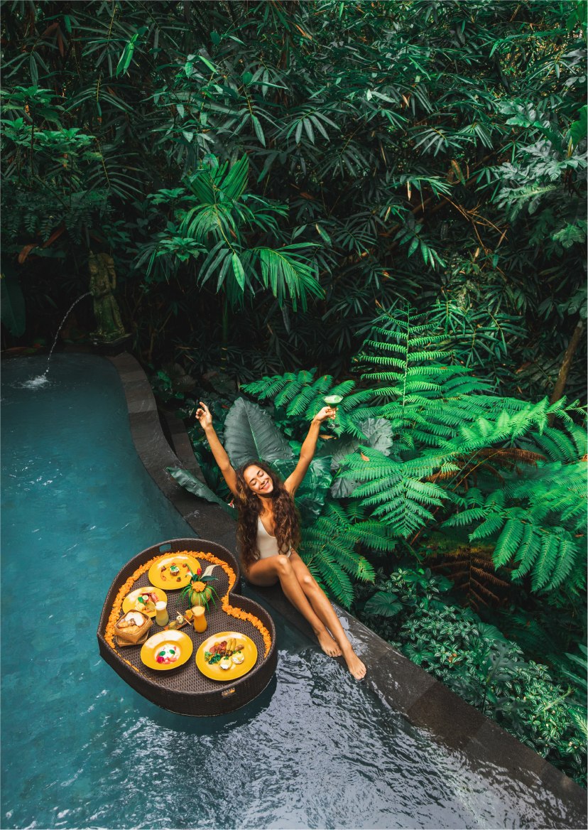 Woman in swimsuit in exotic location lying by a pool